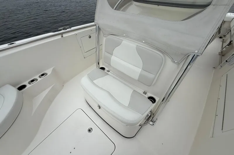  Yacht Photos Pics 2013 Edgewater 318CC boat interior with white seating and cup holders.