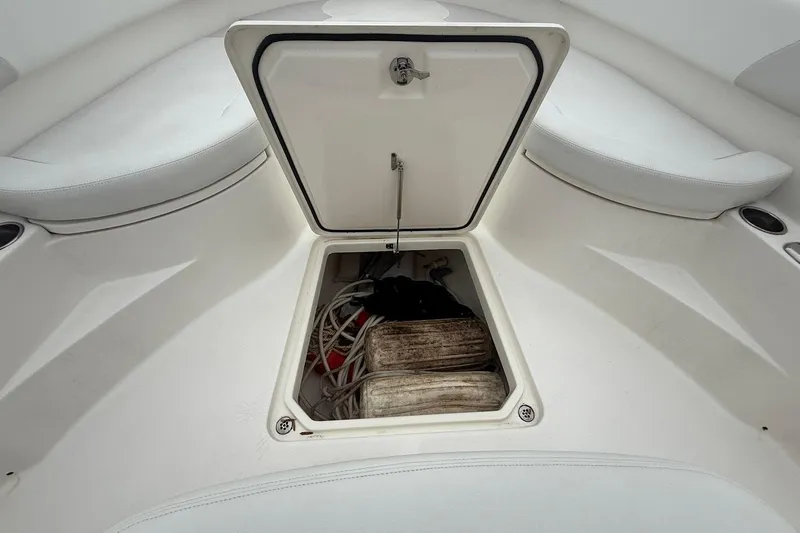  Yacht Photos Pics Open storage compartment on 2013 Edgewater 318CC boat, showing ropes and equipment.