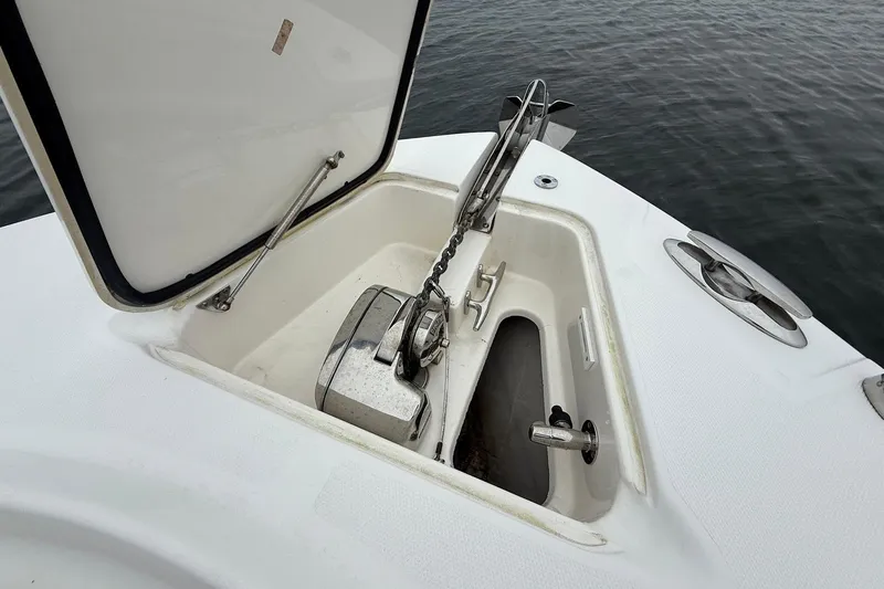  Yacht Photos Pics Anchor compartment of 2013 Edgewater 318CC boat, open on calm water.
