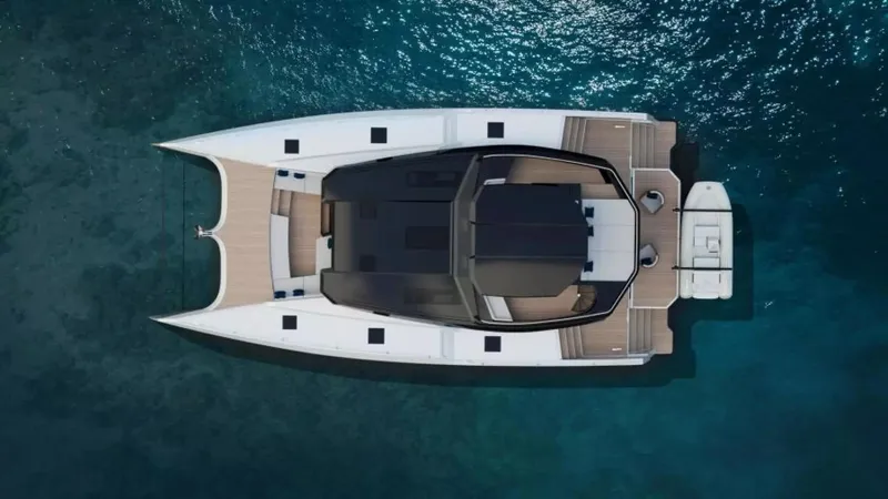  Yacht Photos Pics Aerial view of 2026 McConaghy MC63P Tourer catamaran on clear blue water.