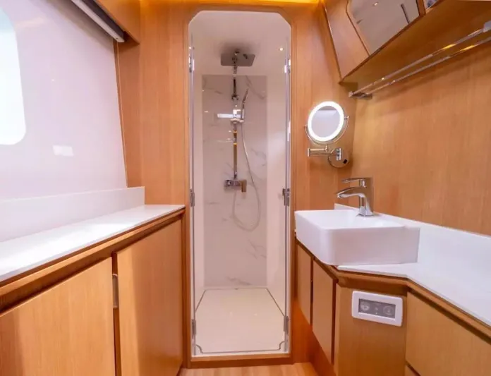  Yacht Photos Pics Luxurious bathroom interior of 2026 McConaghy MC63P Tourer yacht, featuring modern fixtures and wood accents.