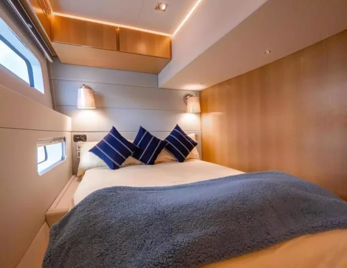  Yacht Photos Pics Luxurious cabin interior of 2026 McConaghy MC63P Tourer with cozy bedding and modern lighting.