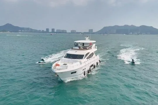  Yacht Photos Pics Sunseeker Manhattan 73 yacht cruising with jet skis, 2013 model, on open water.