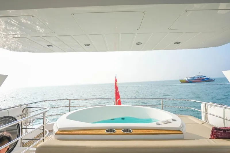  Yacht Photos Pics Luxurious Sunseeker Manhattan 73 yacht with jacuzzi, ocean view, and distant boat, 2013 model.