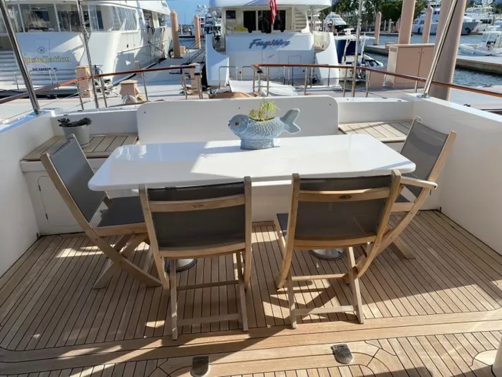 Sea Bold Yacht Photos Pics Teak deck with dining table on 2003 New England Boatworks yacht, Enclosed Raised Pilothouse.