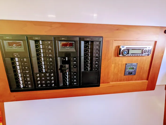 Grand Cove Yacht Photos Pics Electrical control panel on a 2014 Back Cove 34 boat, featuring switches and a stereo system.