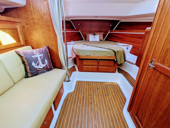 Grand Cove Yacht Photos Pics 2014 Back Cove 34 interior with wood finish, cozy bed, and nautical-themed decor.