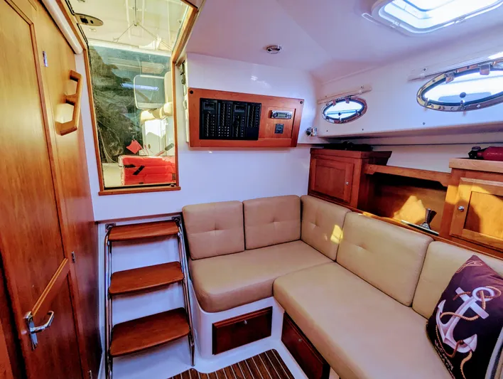 Grand Cove Yacht Photos Pics 2014 Back Cove 34 interior with beige seating, wooden accents, and nautical decor.