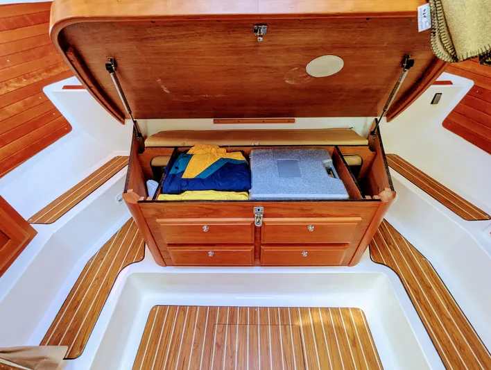 Grand Cove Yacht Photos Pics 2014 Back Cove 34 boat interior with open wooden storage compartment and neatly arranged items.
