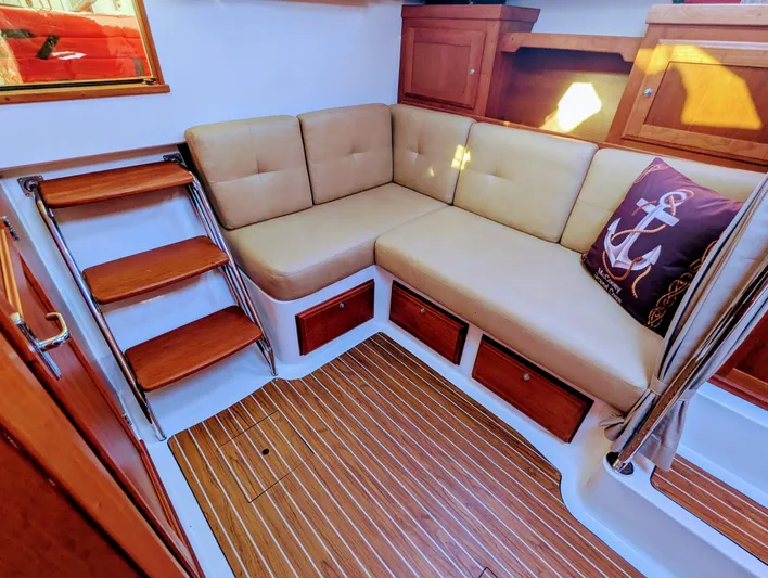 Grand Cove Yacht Photos Pics Interior of 2014 Back Cove 34 boat with cushioned seating and wooden flooring.