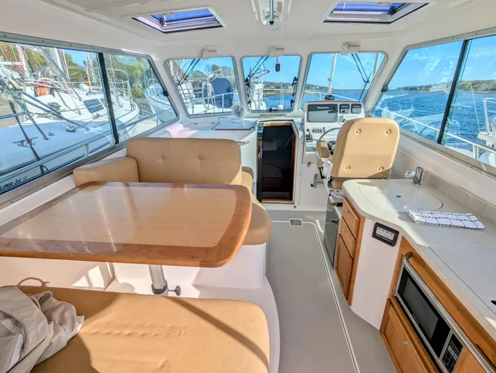 Grand Cove Yacht Photos Pics 2014 Back Cove 34 yacht interior with seating, table, and helm, showcasing luxury and comfort.