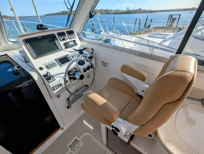 Grand Cove Yacht Photos Pics Helm of 2014 Back Cove 34 boat with steering wheel and navigation controls.