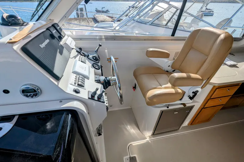 Grand Cove Yacht Photos Pics Helm of 2014 Back Cove 34 boat with tan captain's chair and navigation controls.