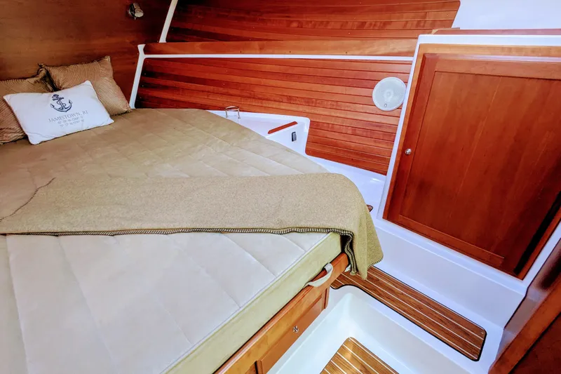 Grand Cove Yacht Photos Pics 2014 Back Cove 34 cabin interior with wooden paneling and cozy bed.