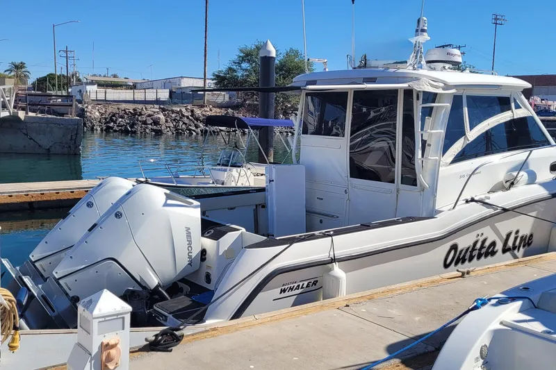 Outta Line Yacht Photos Pics 2017 Boston Whaler 315 Conquest boat docked with twin Mercury engines.
