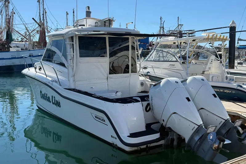 Outta Line Yacht Photos Pics 2017 Boston Whaler 315 Conquest boat docked with twin outboard engines.
