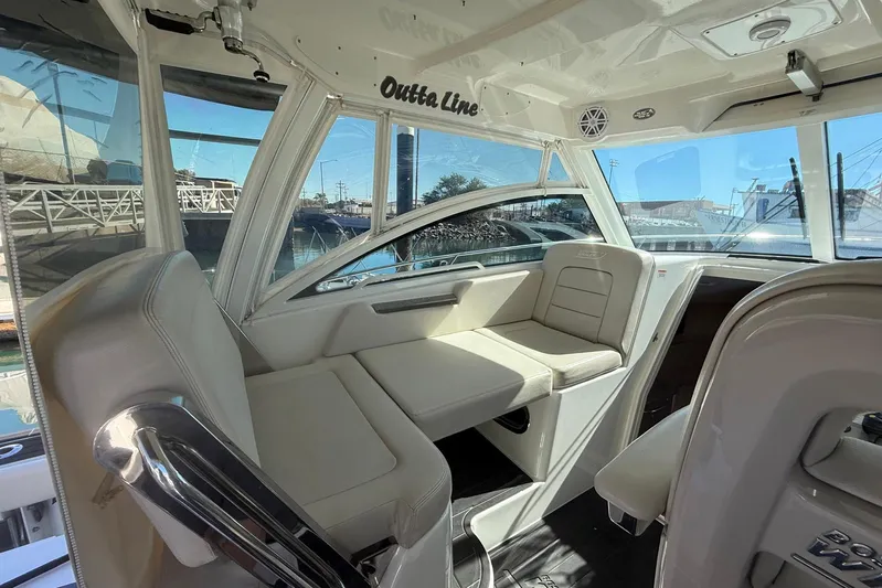 Outta Line Yacht Photos Pics Interior of a 2017 Boston Whaler 315 Conquest boat with beige seating.