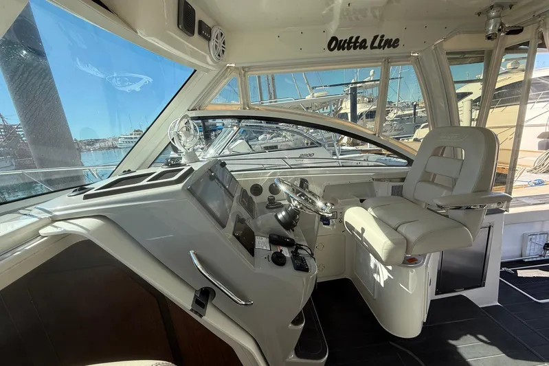 Outta Line Yacht Photos Pics 2017 Boston Whaler 315 Conquest helm with modern controls and comfortable seating.