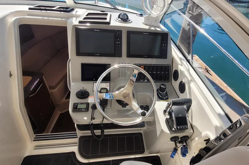 Outta Line Yacht Photos Pics 2017 Boston Whaler 315 Conquest helm with dual screens and steering wheel.