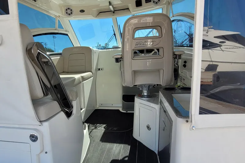 Outta Line Yacht Photos Pics Interior of 2017 Boston Whaler 315 Conquest boat with seating and helm.