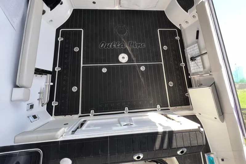 Outta Line Yacht Photos Pics 2017 Boston Whaler 315 Conquest boat deck with black non-slip surface and storage compartments.