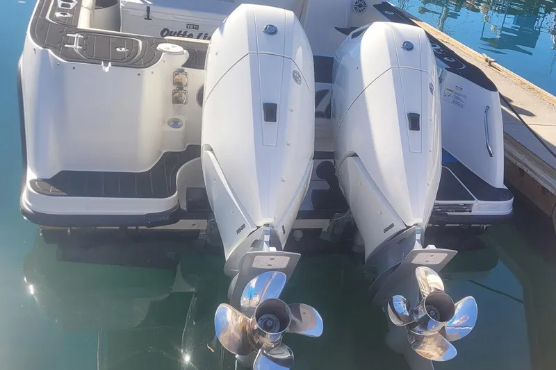 Outta Line Yacht Photos Pics 2017 Boston Whaler 315 Conquest with dual outboard engines at dock.