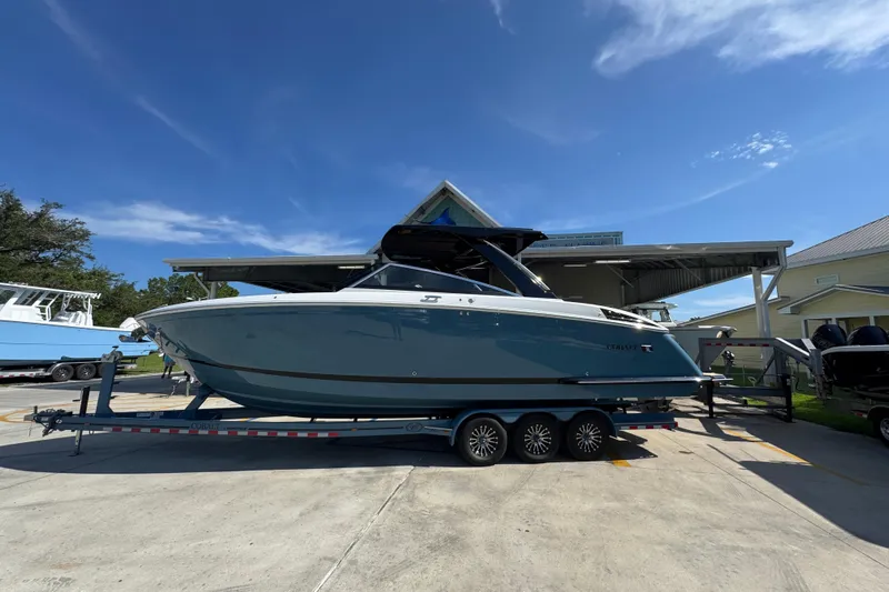  Yacht Photos Pics 2024 Cobalt R33 boat on trailer under clear blue sky.