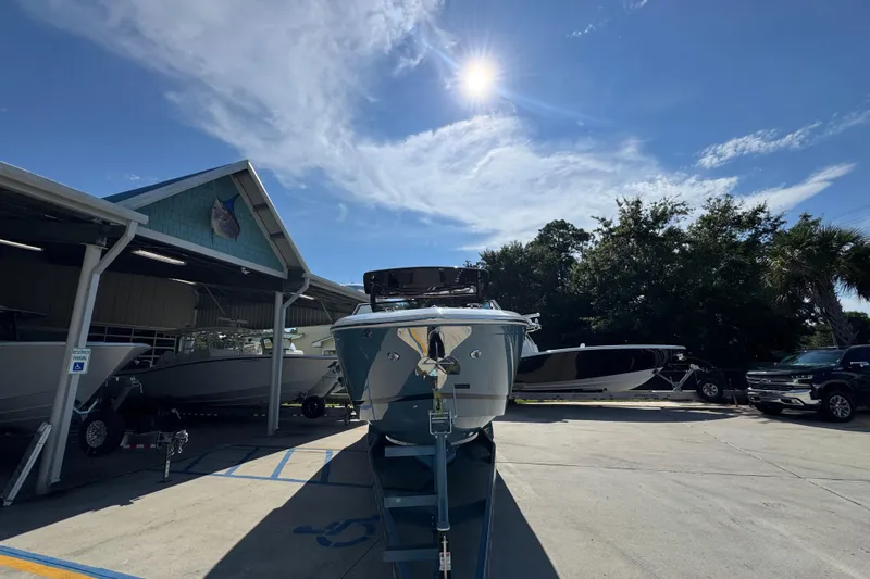  Yacht Photos Pics 2024 Cobalt R33 boat parked outdoors under a sunny sky.