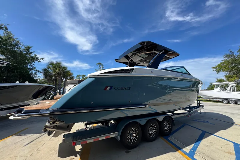  Yacht Photos Pics 2024 Cobalt R33 boat on trailer under clear blue sky.
