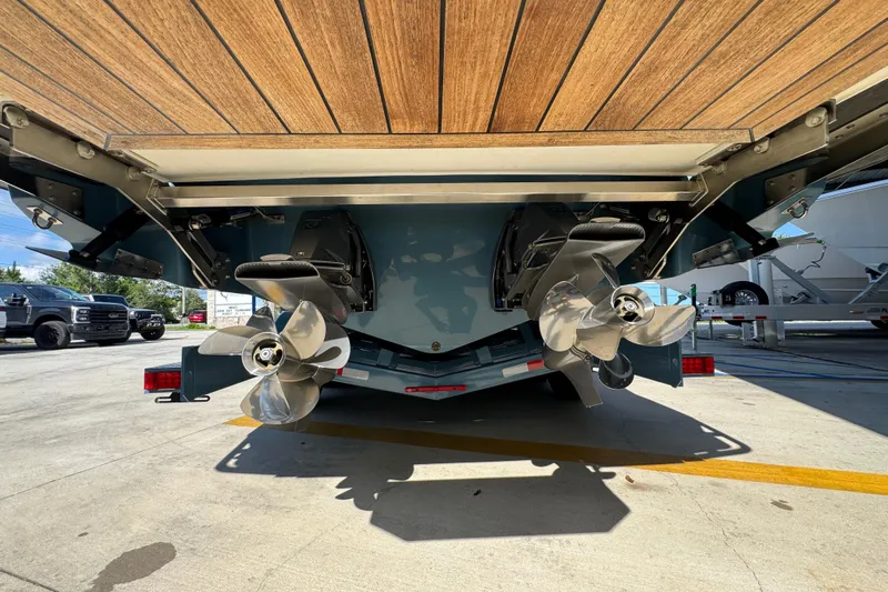  Yacht Photos Pics 2024 Cobalt R33 boat with dual propellers and wooden deck, parked outdoors.