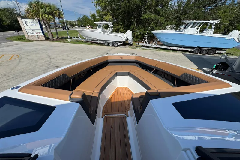  Yacht Photos Pics 2024 Cobalt R33 boat with luxurious seating and sleek design at a marina.