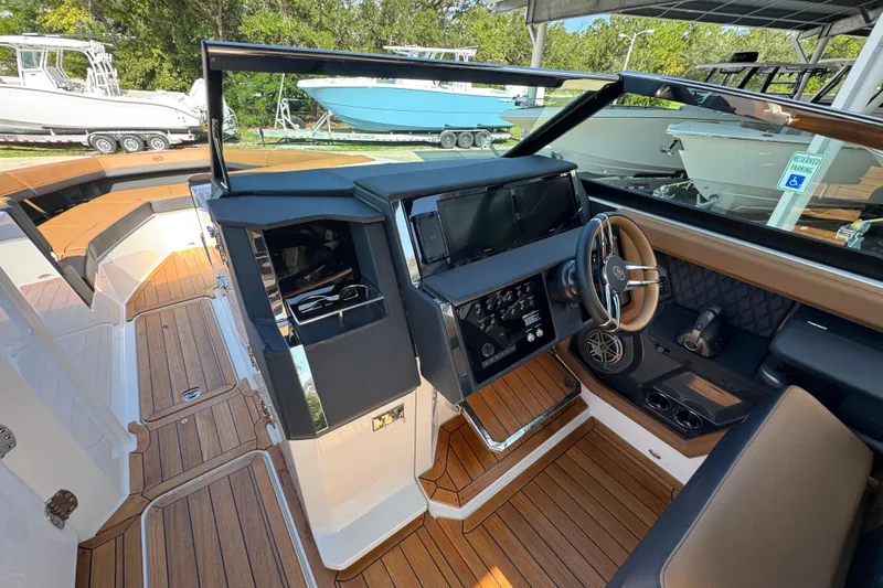  Yacht Photos Pics 2024 Cobalt R33 boat interior with modern dashboard and wood flooring.