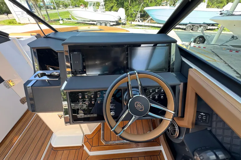  Yacht Photos Pics 2024 Cobalt R33 boat helm with modern controls and sleek steering wheel design.