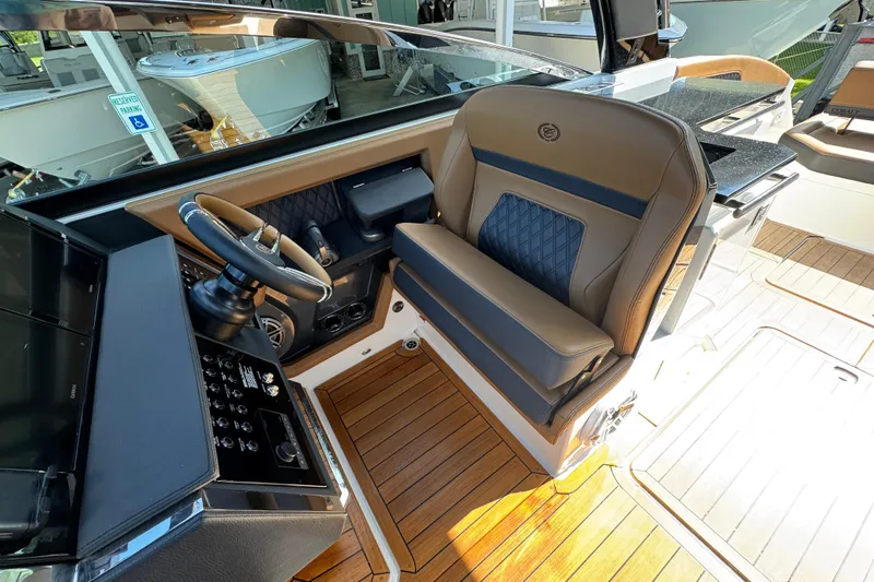  Yacht Photos Pics 2024 Cobalt R33 boat interior with luxurious seating and modern steering console.