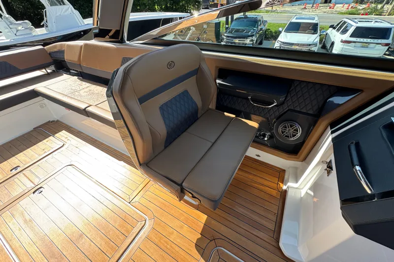  Yacht Photos Pics 2024 Cobalt R33 boat interior with luxurious seating and wood flooring.