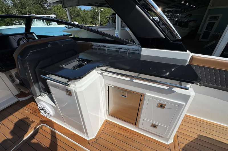  Yacht Photos Pics 2024 Cobalt R33 boat interior with sleek kitchen area and modern design.