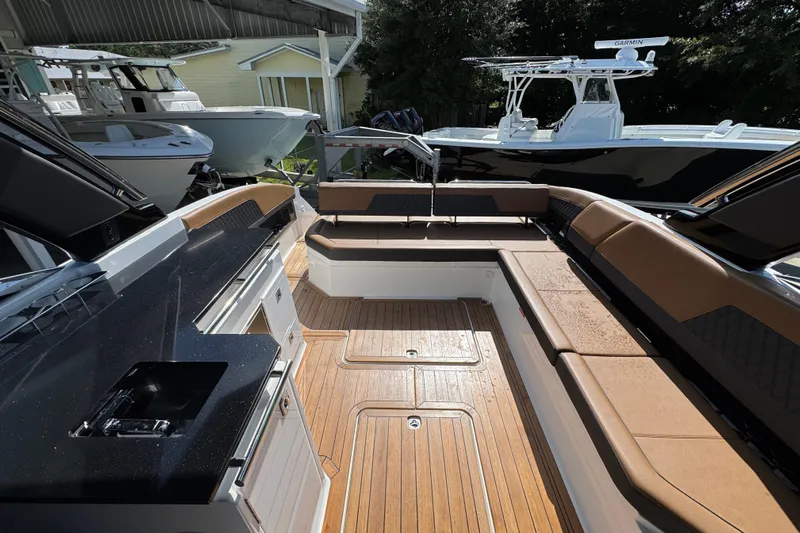  Yacht Photos Pics 2024 Cobalt R33 boat interior with luxurious seating and sleek design.