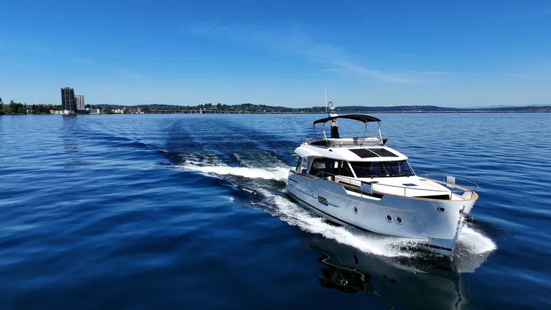  Yacht Photos Pics 2024 Greenline 48 Fly yacht cruising on a calm blue lake.