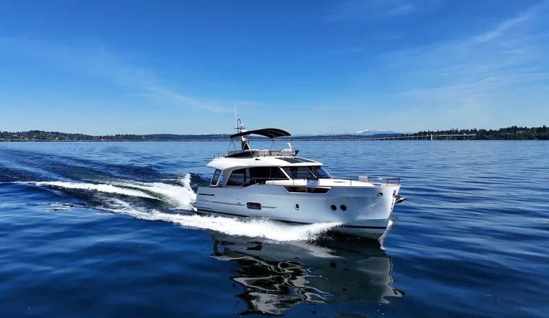  Yacht Photos Pics 2024 Greenline 48 Fly yacht cruising on a clear blue sea.