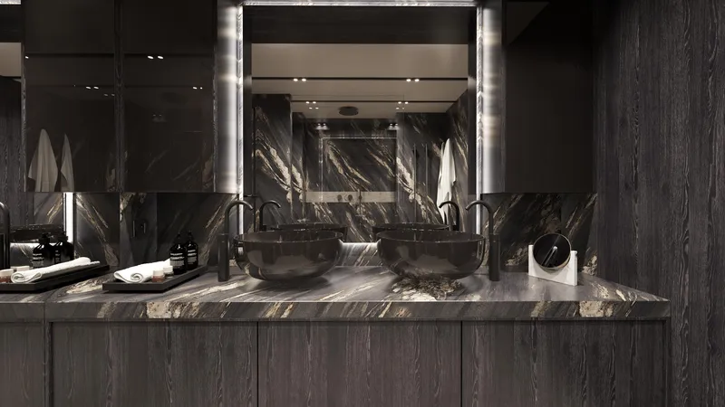 Moon Yacht 100s Yacht Photos Pics Luxurious bathroom with dual sinks, dark marble countertops, and modern fixtures on Moon 100 Sail yacht.