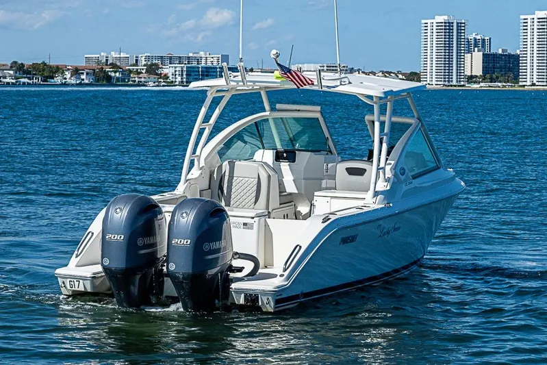 T/t Lucky Seven Yacht Photos Pics 2022 Pursuit DC 266 Dual Console boat on water with twin Yamaha engines.