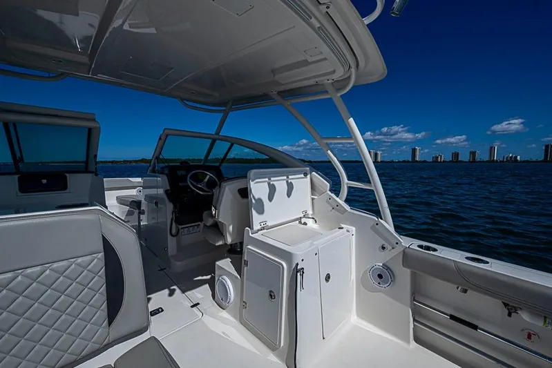T/t Lucky Seven Yacht Photos Pics 2022 Pursuit DC 266 Dual Console boat interior on open water, clear sky background.