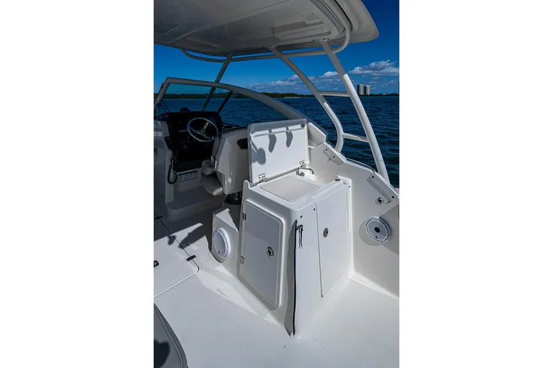 T/t Lucky Seven Yacht Photos Pics 2022 Pursuit DC 266 Dual Console boat interior with helm and sink, on open water.