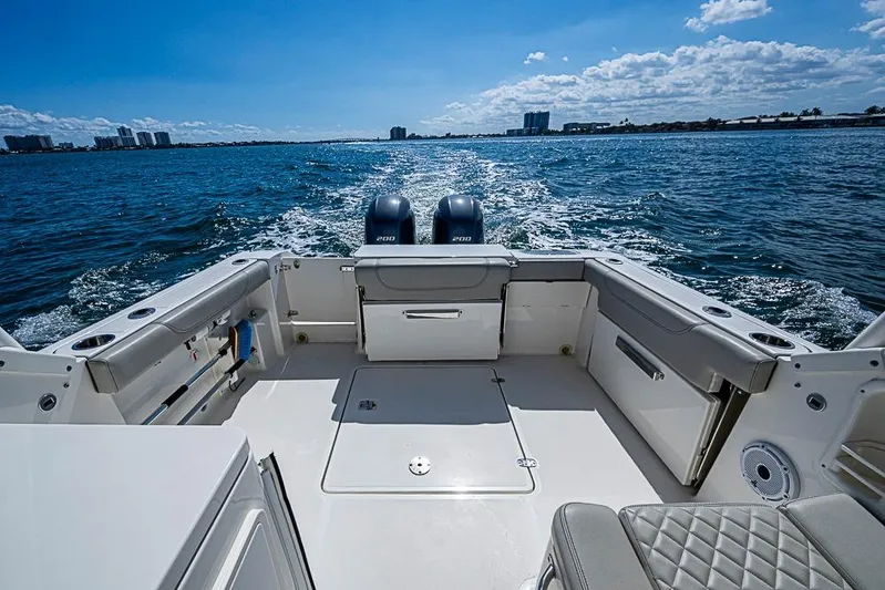 T/t Lucky Seven Yacht Photos Pics 2022 Pursuit DC 266 Dual Console boat on open water, showcasing spacious deck and twin engines.