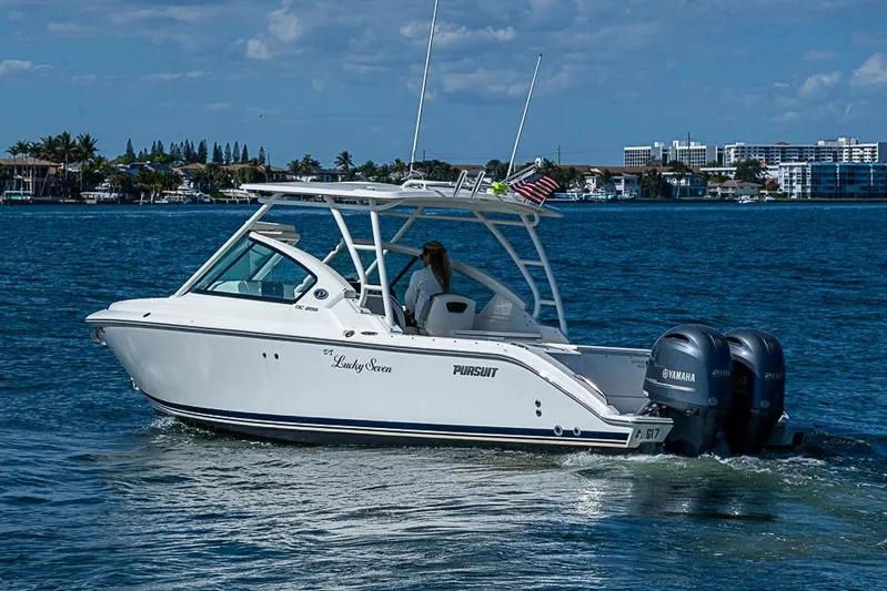 T/t Lucky Seven Yacht Photos Pics 2022 Pursuit DC 266 Dual Console boat cruising on a sunny day with twin Yamaha engines.