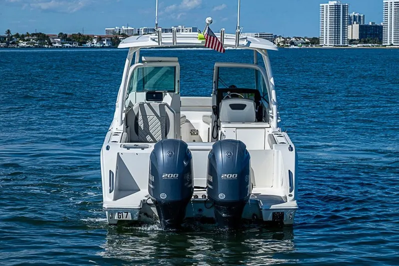 T/t Lucky Seven Yacht Photos Pics 2022 Pursuit DC 266 Dual Console boat on water with twin engines.