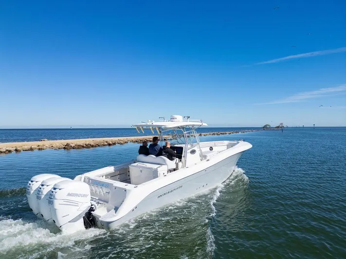 Trident Yacht Photos Pics 2007 Hydra-Sports Vector 3300 CC boat cruising on open water under clear blue skies.
