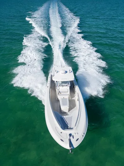Trident Yacht Photos Pics 2007 Hydra-Sports Vector 3300 CC cruising on clear turquoise water.