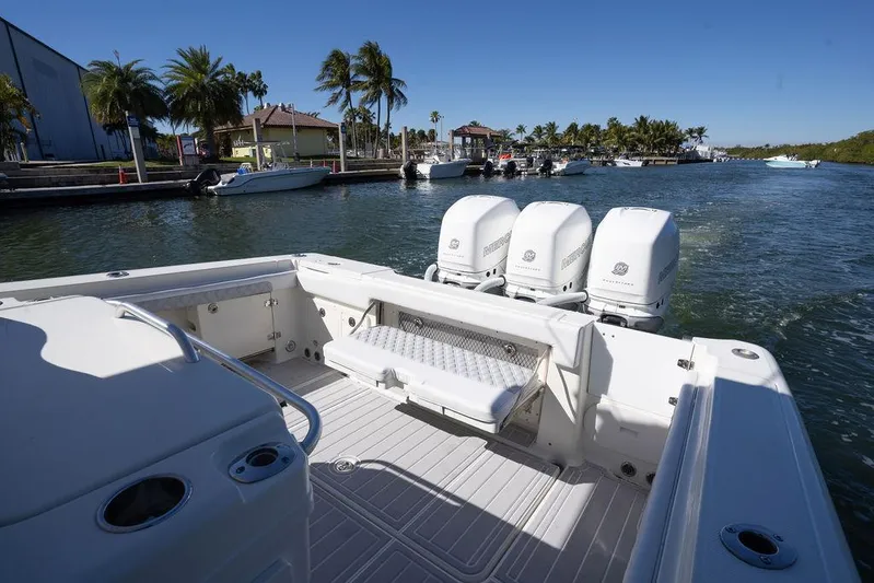 Trident Yacht Photos Pics 2007 Hydra-Sports Vector 3300 CC boat with triple engines, docked in a scenic marina.