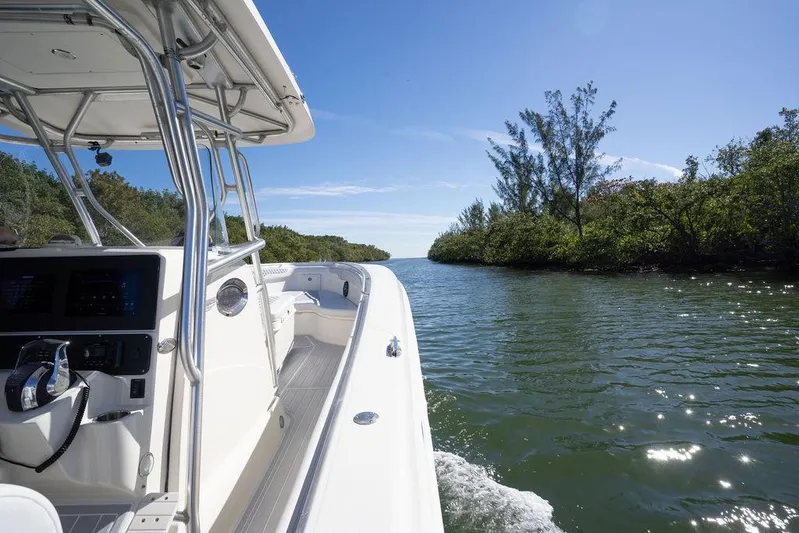 Trident Yacht Photos Pics 2007 Hydra-Sports Vector 3300 CC navigating a scenic waterway under clear blue skies.